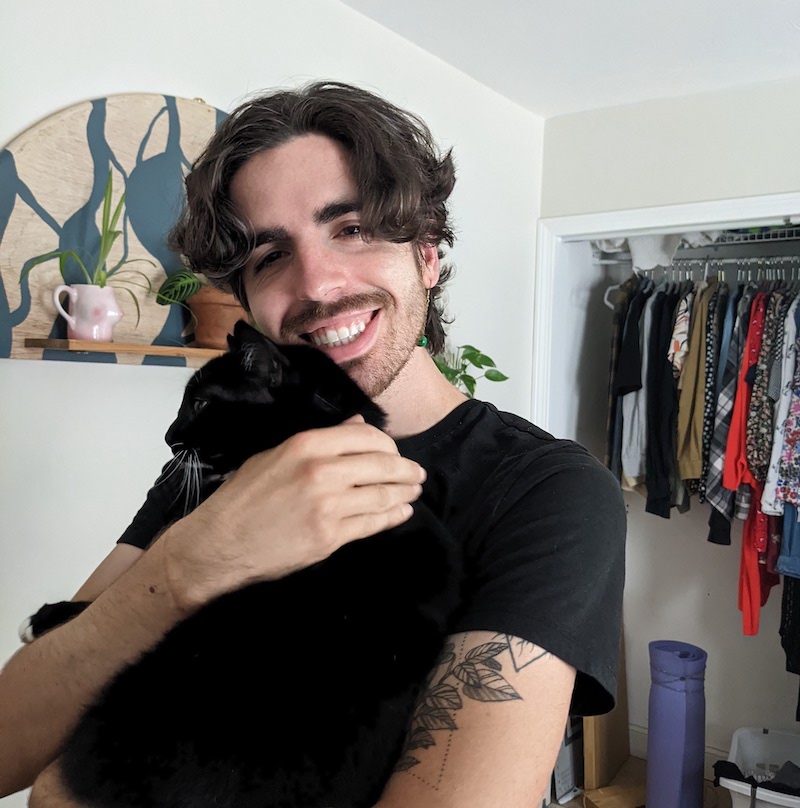 Image of Ben holding his cat.